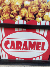Load image into Gallery viewer, Caramel sign on the front of the store with caramel popcorn on top
