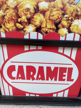 Load image into Gallery viewer, Caramel sign on the front of the store with caramel popcorn on top