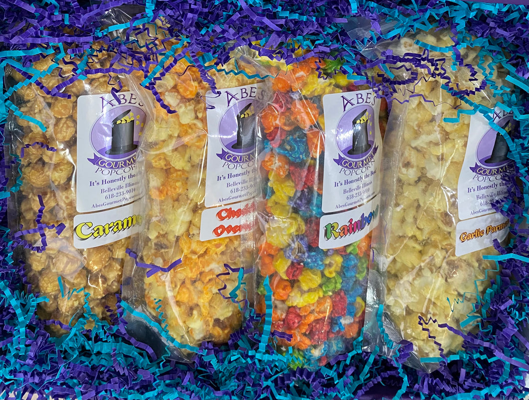 Inside of a gift box containing 4 bags of different flavors of gourmet popcorn.