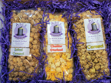 Load image into Gallery viewer, Inside of a gift box containing 3 flavors of gourmet popcorn.
