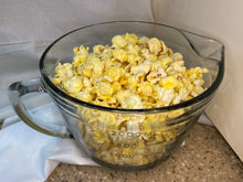 Load image into Gallery viewer, Dill pickle popcorn in a glass bowl.
