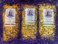 Inside contents of Belleville Box: 1 bag of Abe's Mix popcorn, 1 bag of Caramel popcorn and 1 bag of Belleville Blend popcorn surrounded by crinkle paper and wrapped in tissue to make opening an experience 