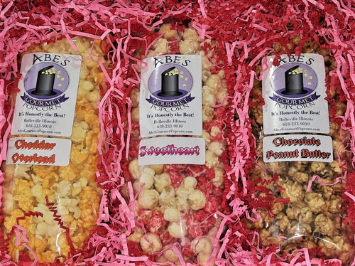 contents of Sweetheart gift box: 1 bag Cheddar Overload popcorn, 1 bag of Sweetheart popcorn and 1 bag of chocolate peanut butter popcorn 